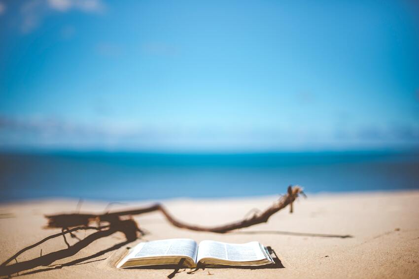 Book open on the beach by the ocean